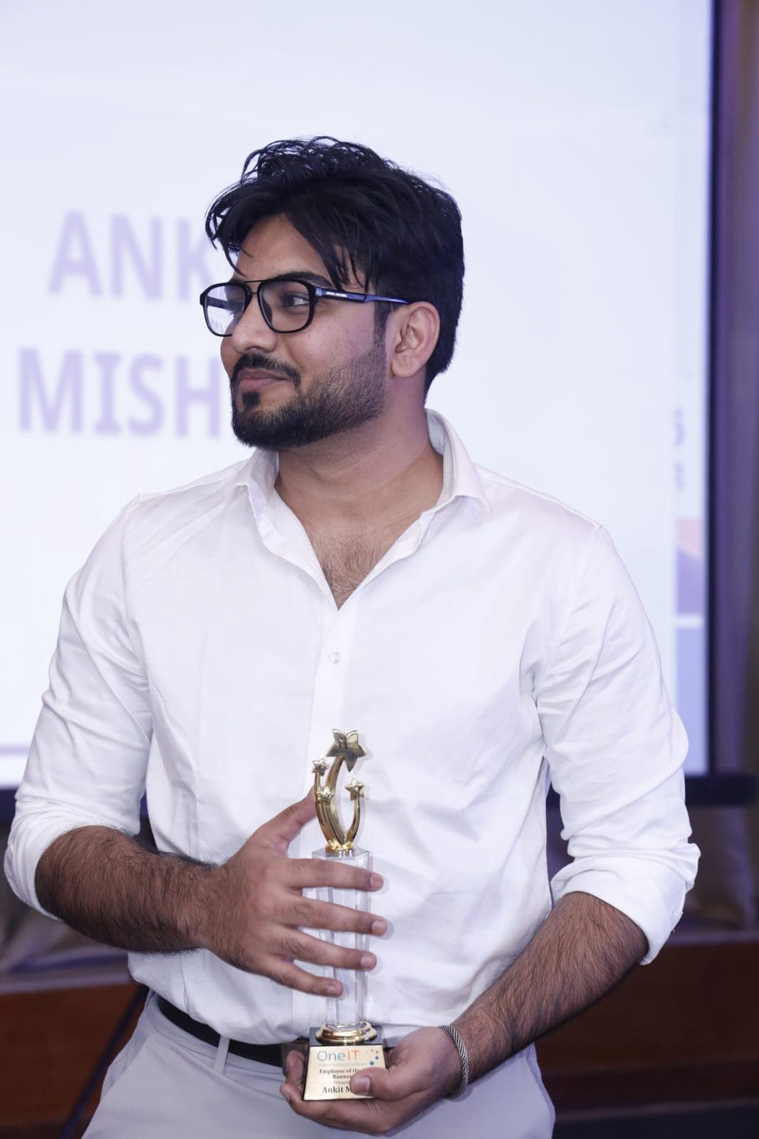 Ankit Mishra holding the OneIT Runner-up Employee of the Year 2025 trophy